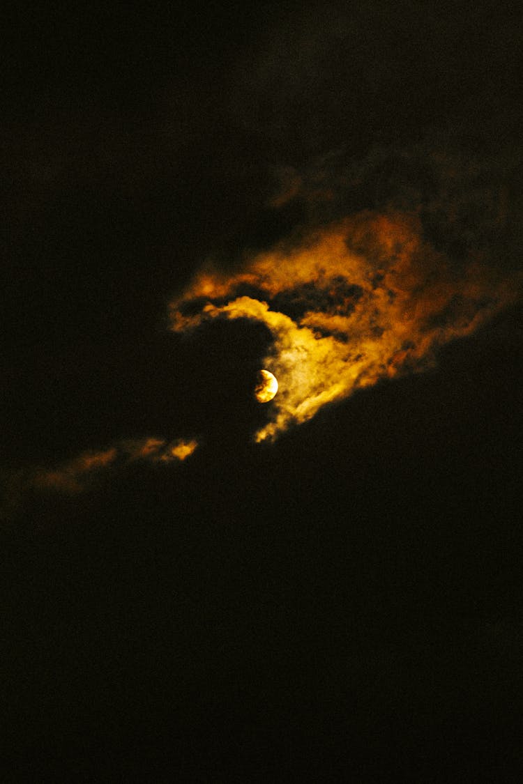 Moon Shining In Cloudy Sky At Night