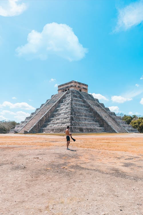 A Man Standing Near the Concrete Pyrmaid