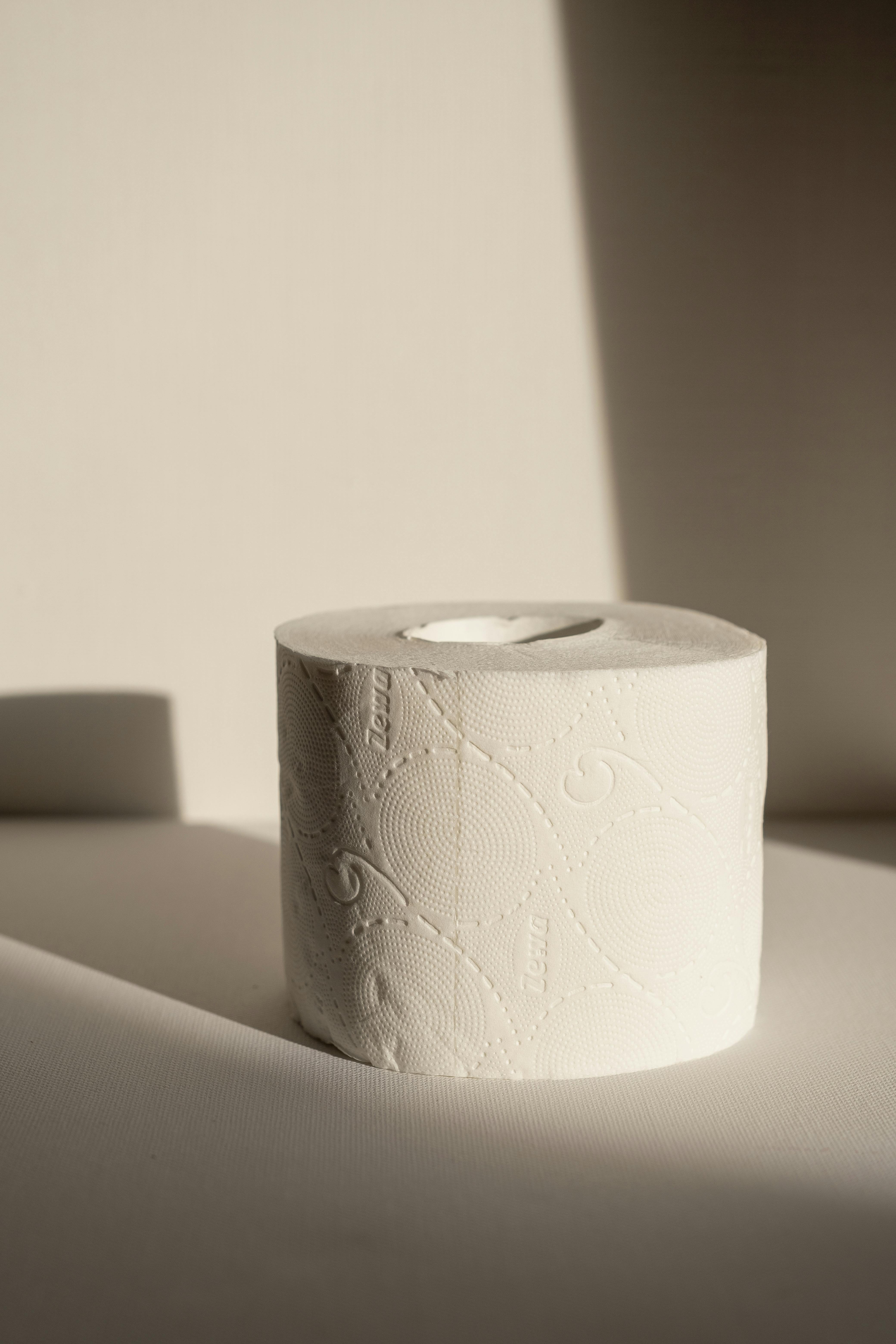 Close-up Shot Of A Tissue Paper Roll On A White Surface · Free Stock Photo