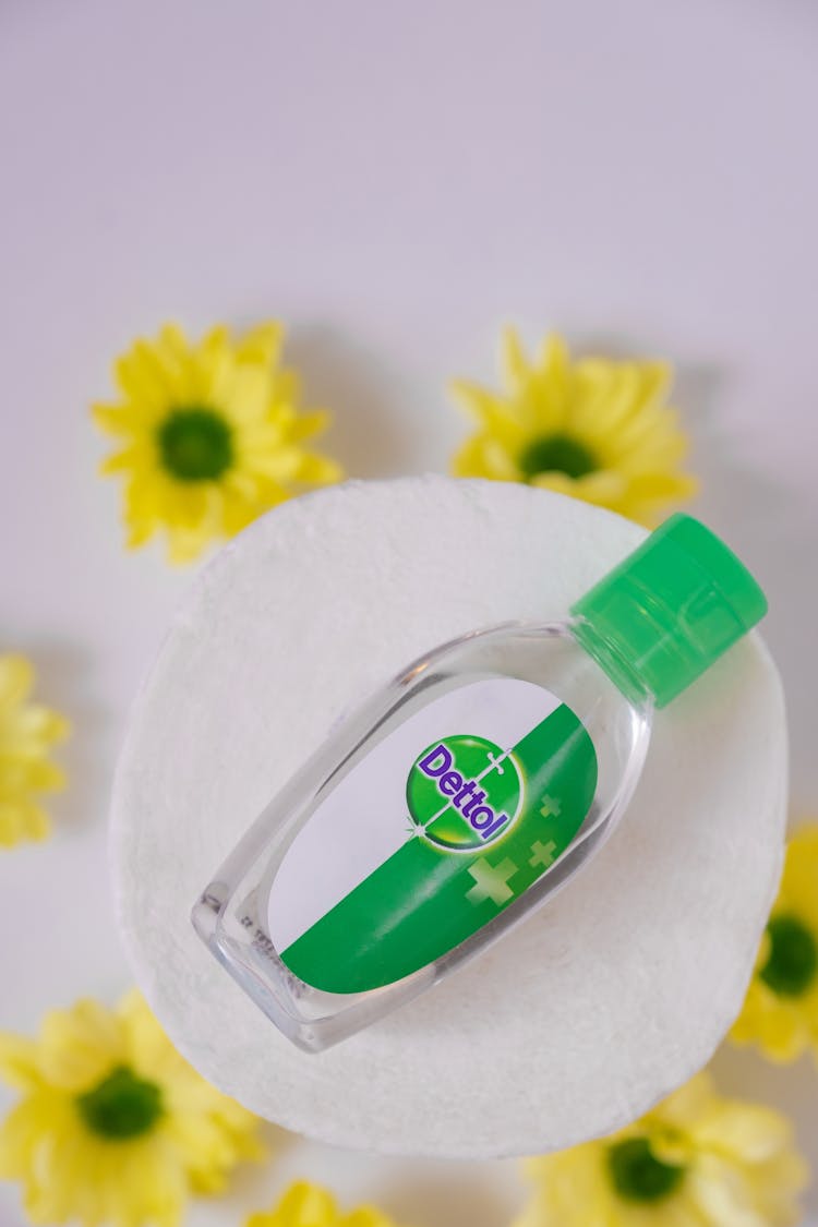 Disinfectant Liquid On Plate And Yellow Flowers