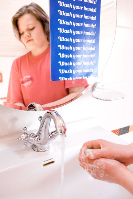 child washing hands with soap