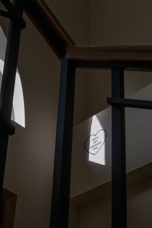 Free A motivational message placed in a sunlit stairwell with shadows casting ambient light. Stock Photo
