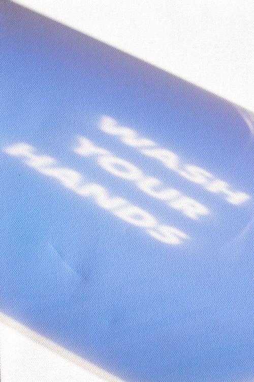 Free Text urging hand washing over a blue background, blurred effect. Stock Photo