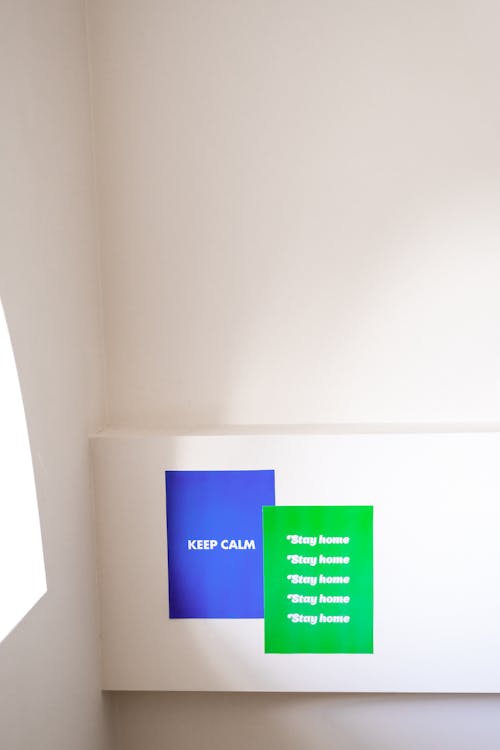 Blue and Green Slogans On White Wall