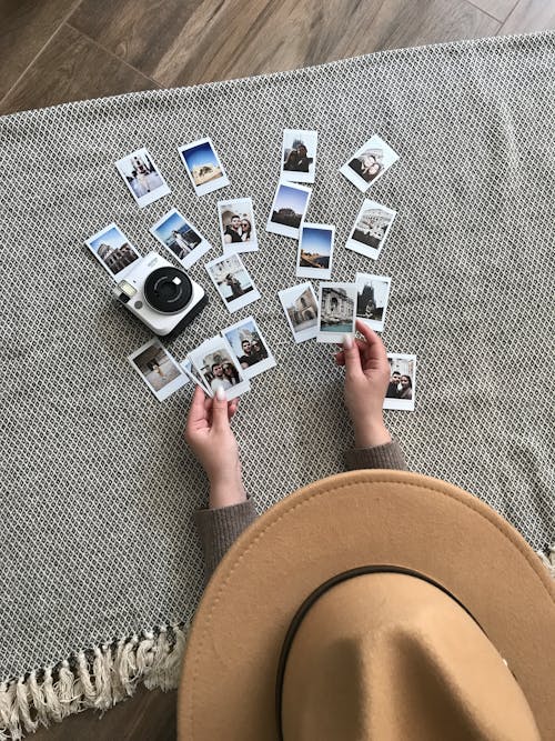 Person Holding Instant Pictures