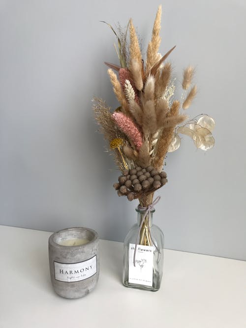 Dried Flowers on Clear Glass Bottle