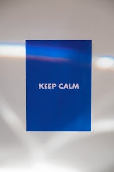 Simple blue poster with 'Keep Calm' text, conveying a sense of tranquility and minimalism.