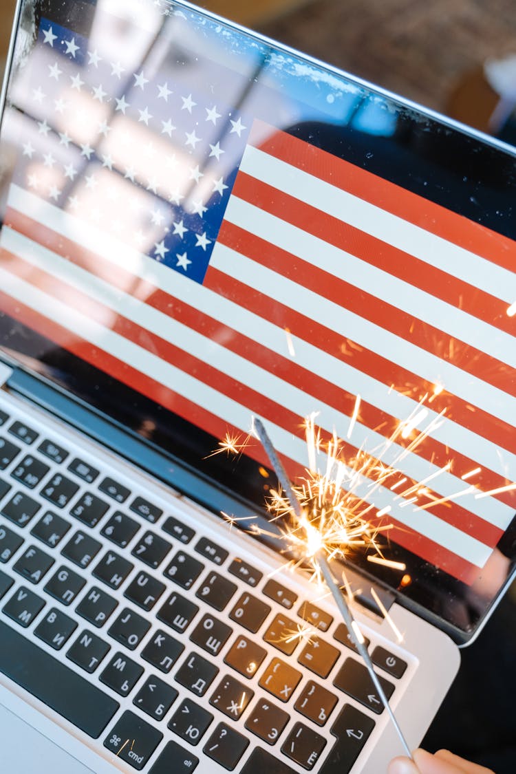 Roman Candle And American Flag On Laptop Screen