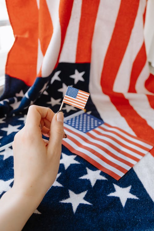 Free Hand Holding Miniature of American Flag Stock Photo