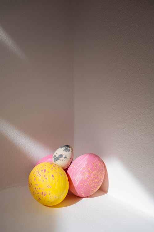 Pink and Yellow Easter Eggs With a Quail Egg