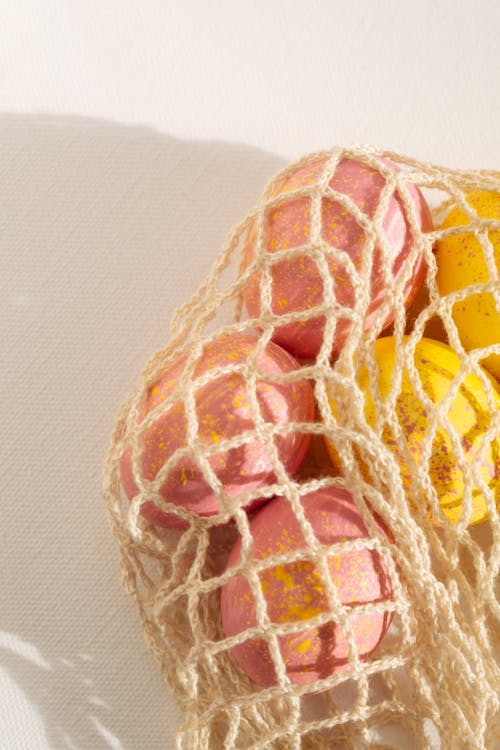 Pink and Yellow Easter Eggs on a Net
