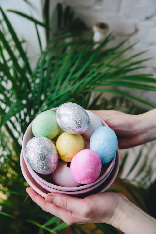Person Holding a Bowl With Easter Eggs
