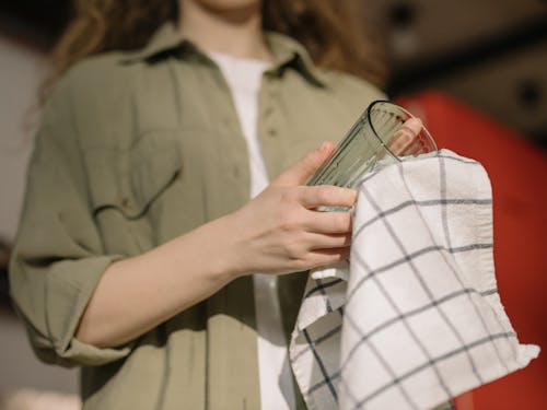 Person in Gray Button Up Shirt Holding Clear Drinking Glass