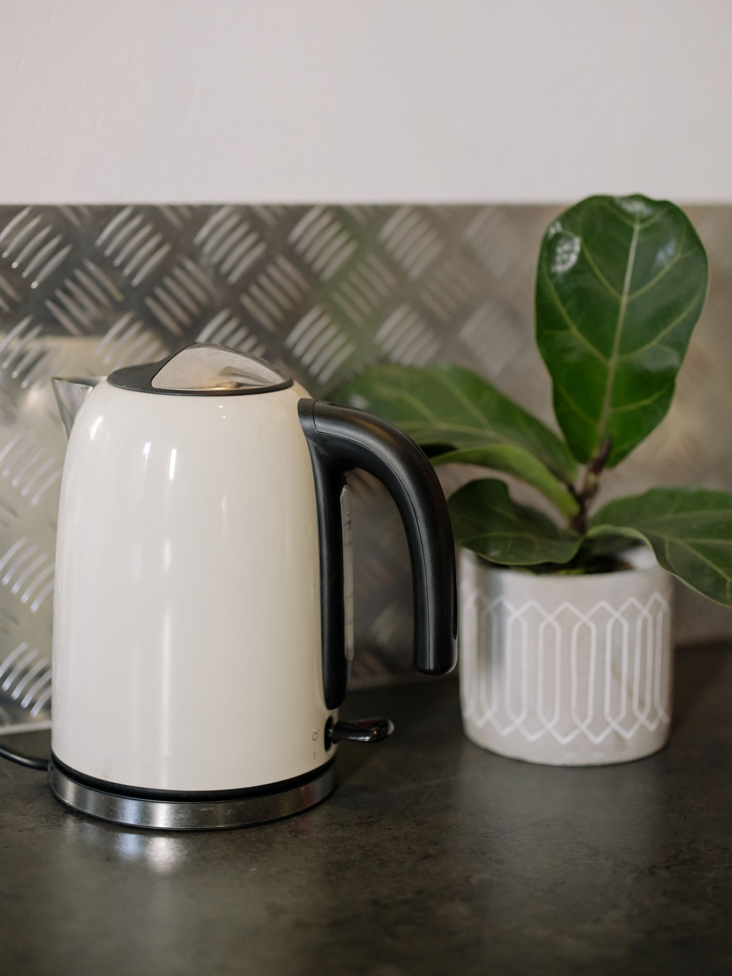 White and black electric kettle on a contemporary kitchen countertop