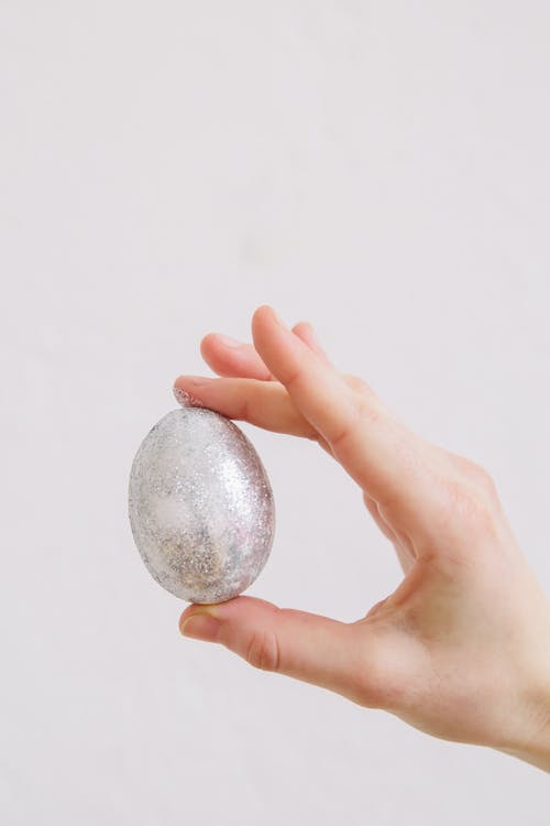 Person Holding a Silver Easter Egg