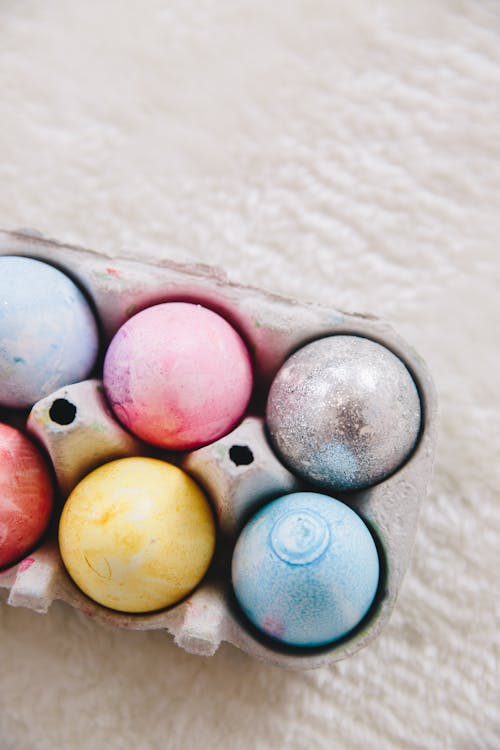 Blue Yellow and Pink Easter Eggs on Gray Egg Tray