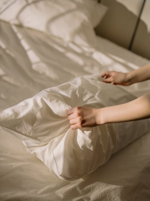 Free Person Lying on White Bed Stock Photo