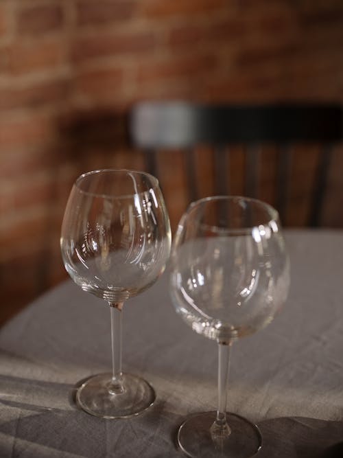 Clear Wine Glass on White Textile