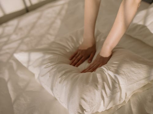 Free Woman in White Dress Lying on Bed Stock Photo