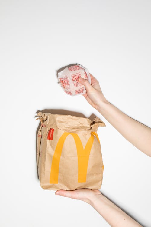 Free A Person Holding a Burger Stock Photo