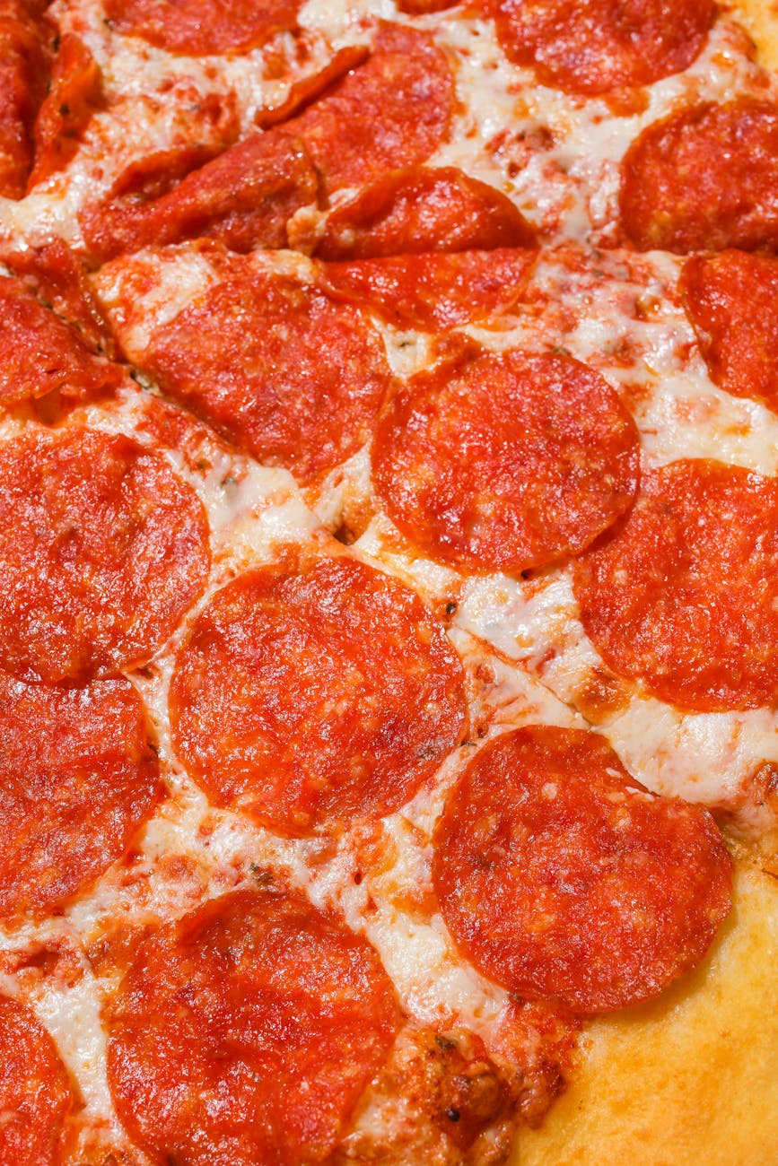 Polina Tankilevitch - Mouth-watering pepperoni pizza with melted cheese and golden crust, perfect for any meal.