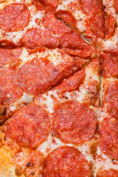 Close-up view of mouth-watering pepperoni pizza slices topped with melted mozzarella.