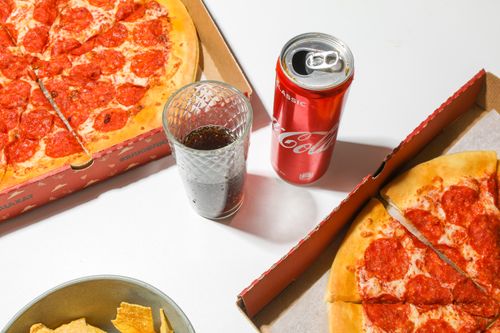 Free Top view of pepperoni pizza, soda, and chips for a delicious meal. Stock Photo