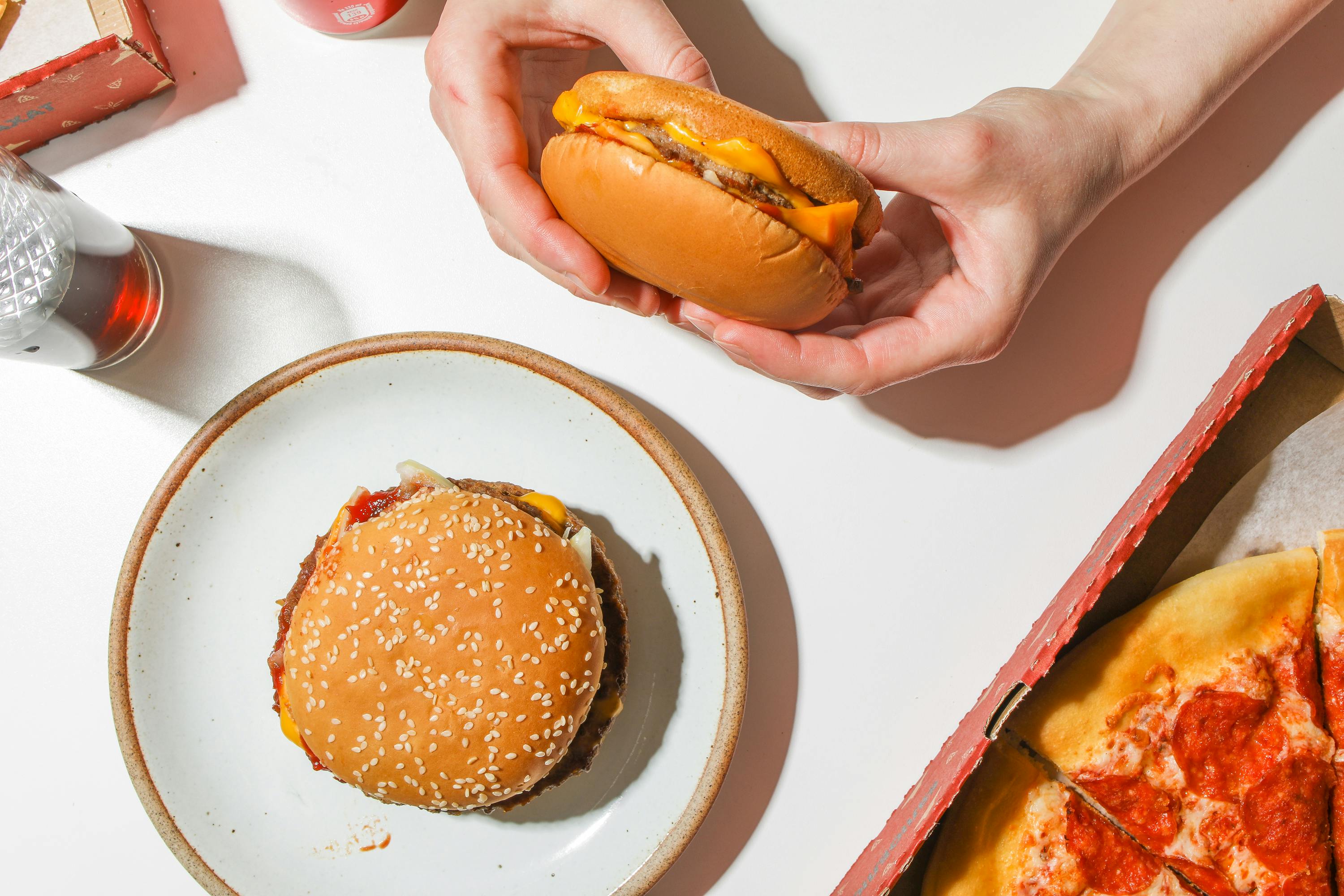 person holding a cheeseburger