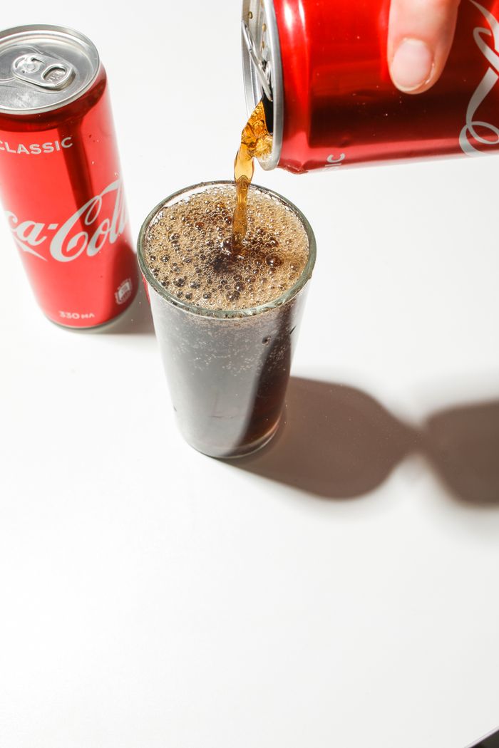 Soda being poured into a drinking glass