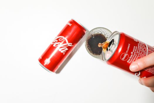 Person Pouring Soda in a Glass