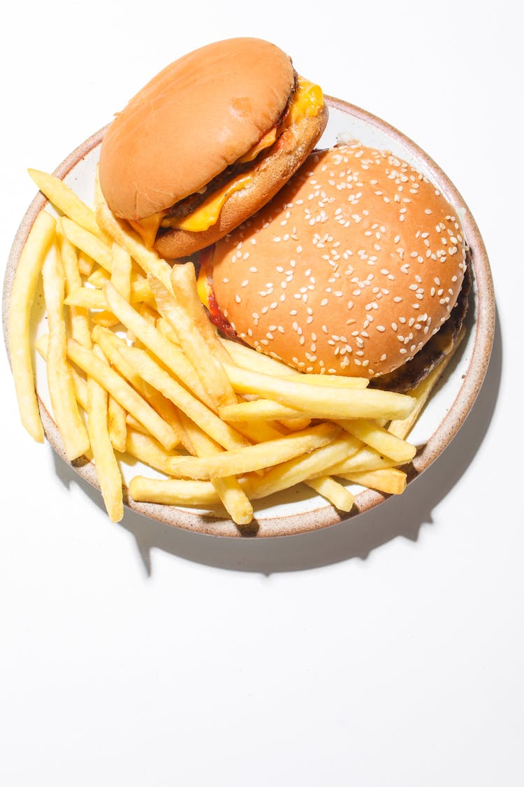 Burgers And Fries On A Ceramic Plate