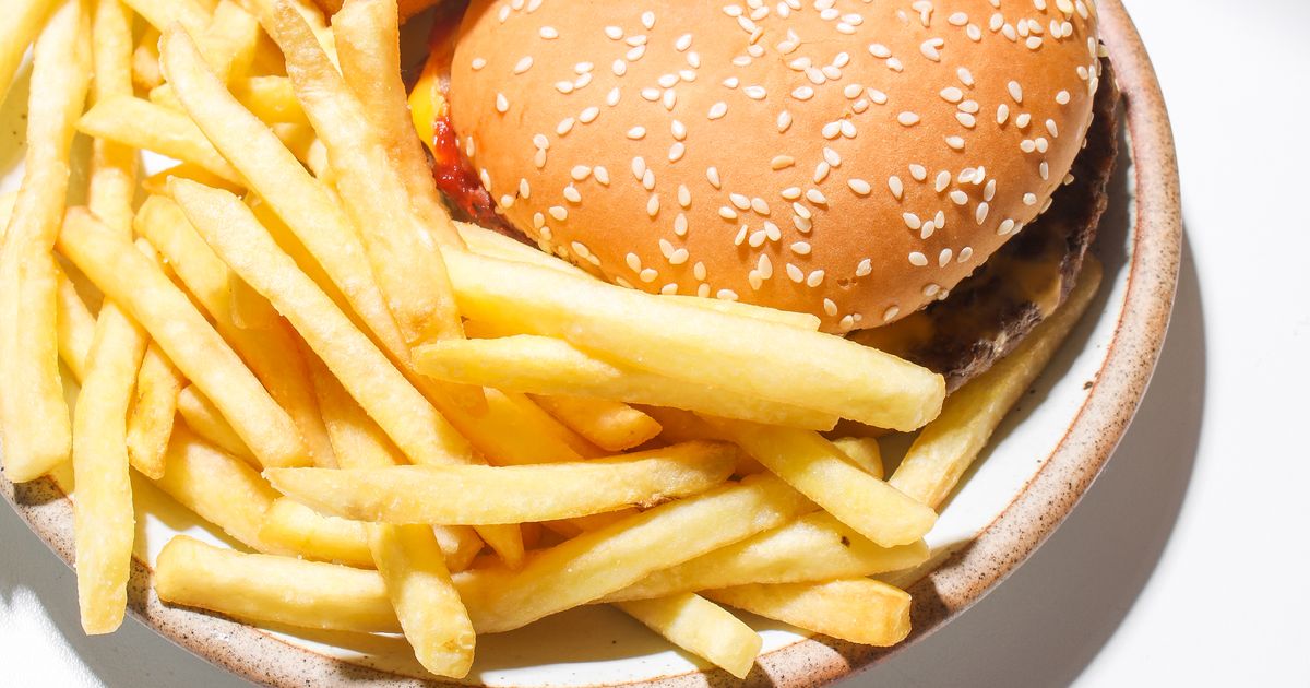 Burgers and fries served on a plate.