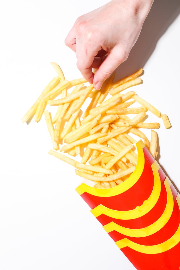 Person Holding French Fries