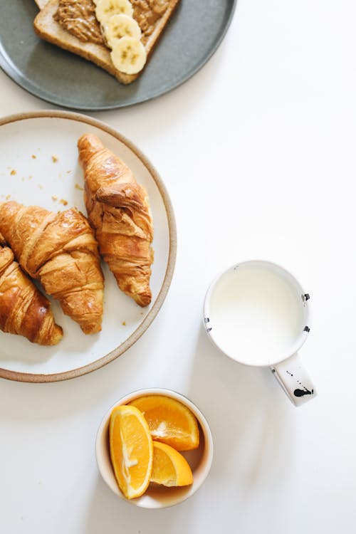 Free Sliced Bread on White Ceramic Plate Beside White Ceramic Mug Stock Photo