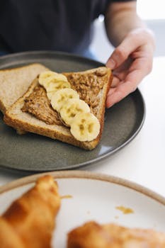 Delicious peanut butter banana toast on a plate, perfect for a healthy breakfast.