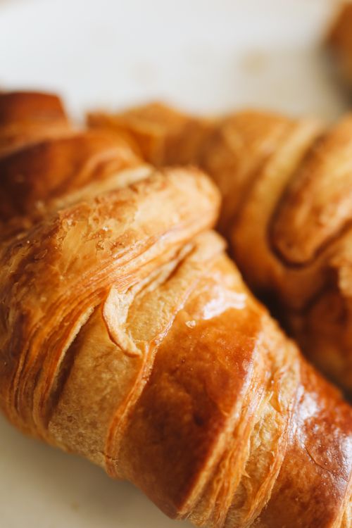 Free Close-up of fresh, flaky croissants showcasing their golden, buttery layers. Stock Photo