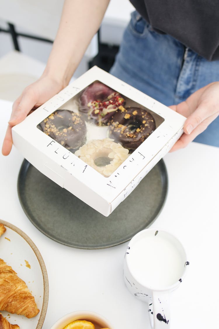 Person Holding A Box Of Donuts