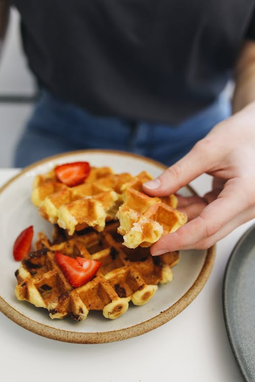 Free A Person Holding a Waffle Stock Photo