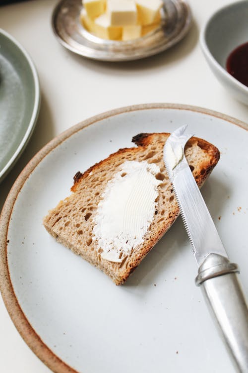 Free A Bread with Butter on a Ceramic Plate Stock Photo