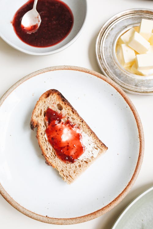 Free A Bread with Jam on a White Ceramic Plate Stock Photo