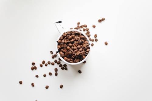 Free White Ceramic Mug Full Of Coffee Beans Stock Photo