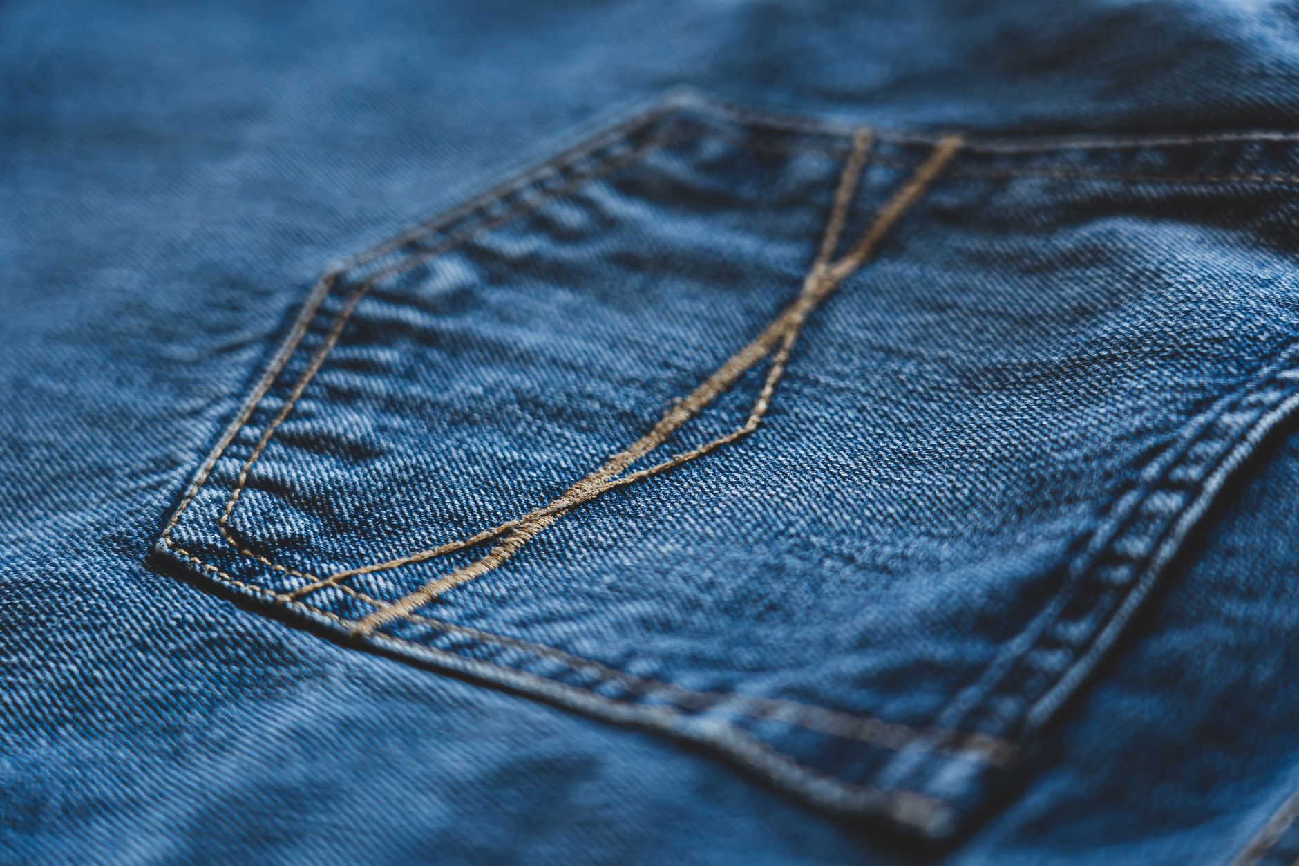 A pair of selvedge denim jeans on a wooden chair