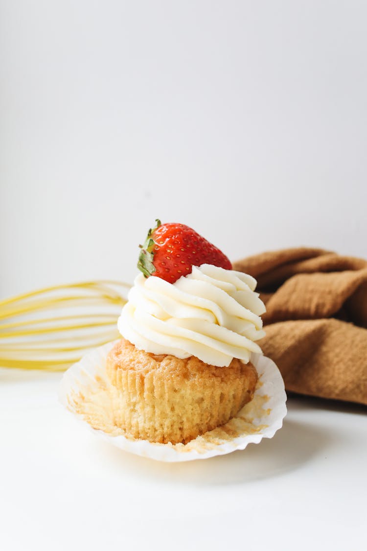 Close-Up Shot Of A Cupcake With Strawberry On Top