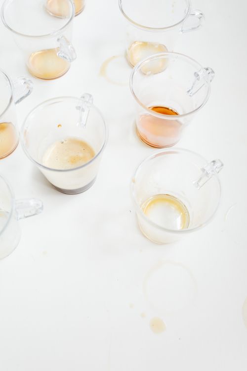 Free A collection of clear empty coffee cups with stains on a white background. Stock Photo