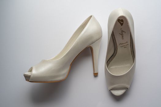 Elegant white bridal high heels with peep-toe design, perfect for weddings.