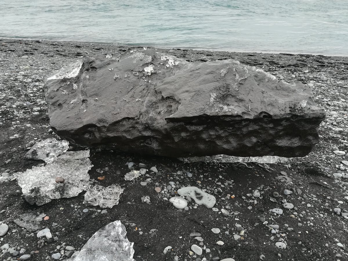 Cooked brown rice and grains fluffed in a pot with a wooden spoon