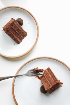 Indulgent chocolate cake slices served on ceramic plates with a fork.