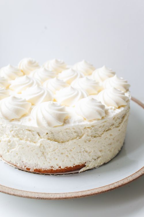 Free Indulge in this creamy cheesecake topped with fluffy whipped cream. Perfect dessert for any occasion. Stock Photo