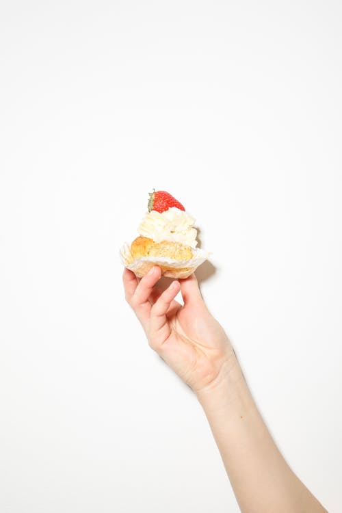 Free Photo Of Person Holding Cupcake Stock Photo