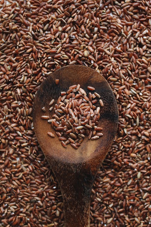 Close-Up Photo Of Brown Rice On Wooden Spoon 